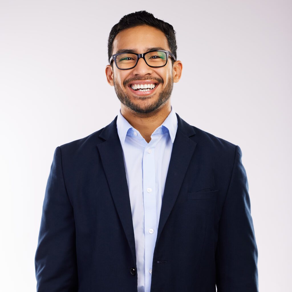 Professional portrait of a smiling man in a business suit and glasses, suitable for a corporate profile or testimonial.